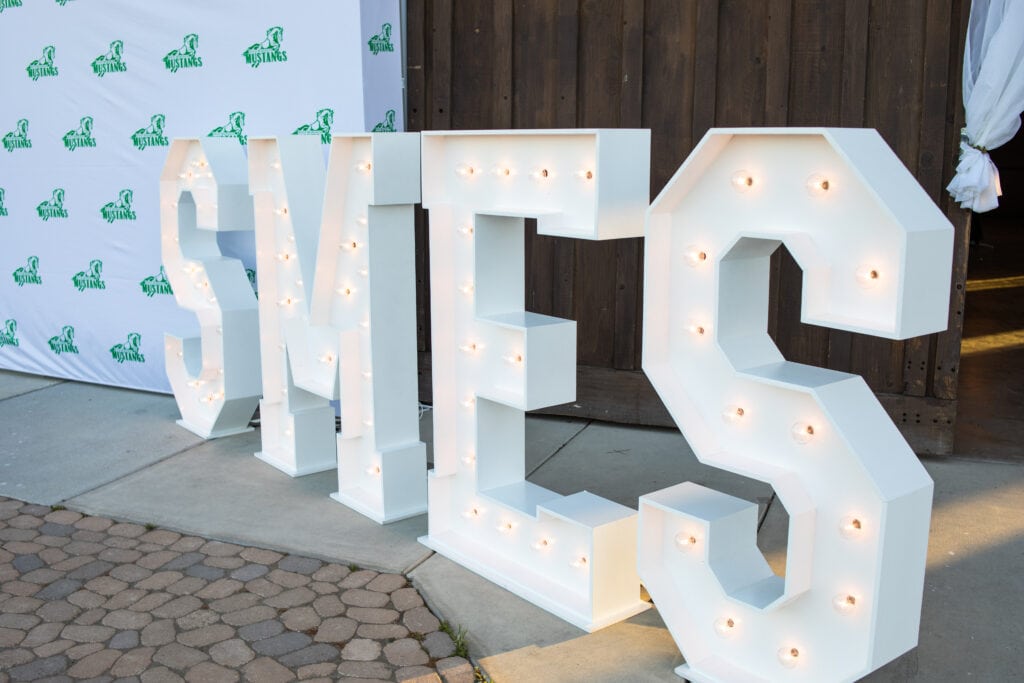 Mustang Ball 2022 Large letters spelling SMES at Oyster Ridge during the 2022 Mustang Ball