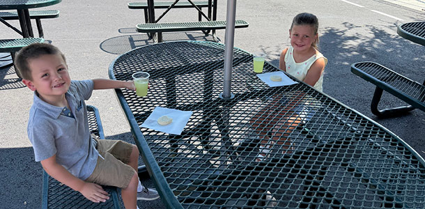 Two students enjoying lemonade and cookies at the TK/Kinder Tea